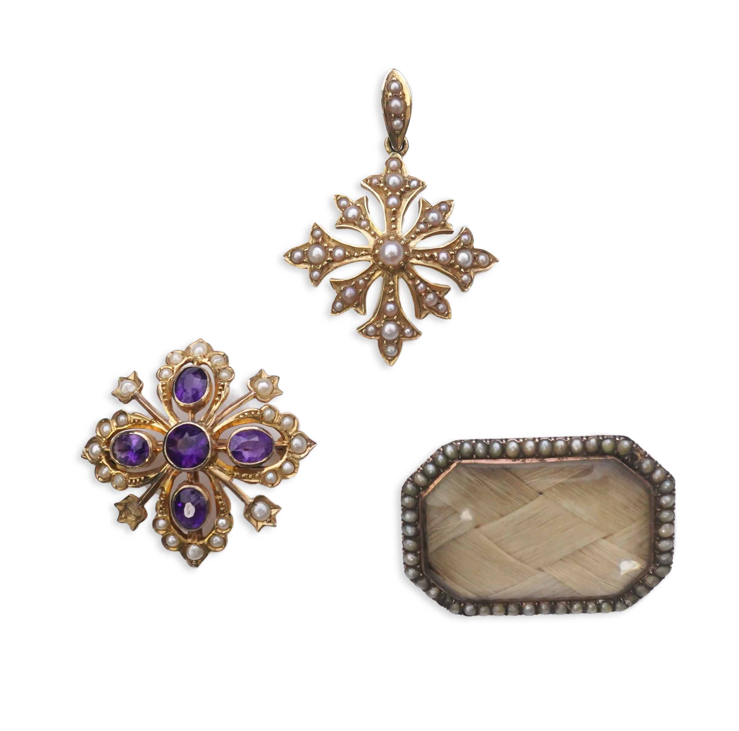 A Georgian mourning brooch, early 19th century, two Edwardian pendants, early 20th century